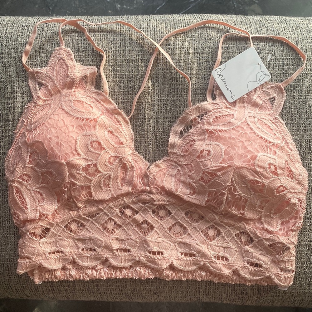Pink lace bralette with adjustable spaghetti straps and removable cups